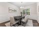 Elegant dining room with modern chandelier, sophisticated wall decor, and ample natural light at 11226 Dappled Light Trl, Charlotte, NC 28227