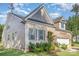Inviting two-story brick home featuring manicured landscaping, gray shutters and complementary gray siding at 11226 Dappled Light Trl, Charlotte, NC 28227