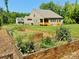 Backyard garden boxes, ready for planting, and a view of the home's rear exterior at 11226 Dappled Light Trl, Charlotte, NC 28227