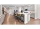 Open-concept kitchen with gray cabinets, a large island with seating, and stainless steel appliances at 11226 Dappled Light Trl, Charlotte, NC 28227