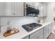 Modern kitchen featuring white subway tile backsplash, stainless steel appliances, and gray cabinetry at 11226 Dappled Light Trl, Charlotte, NC 28227