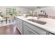 Contemporary kitchen featuring a large island, stainless steel sink, and seamless flow to the dining area at 11226 Dappled Light Trl, Charlotte, NC 28227