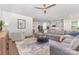 Stylish living room with gray sectional, neutral decor, and seamless flow to the kitchen at 11226 Dappled Light Trl, Charlotte, NC 28227