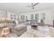 Bright, open living room with large sectional sofa, plush rug, and abundant natural light at 11226 Dappled Light Trl, Charlotte, NC 28227