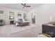 Spacious main bedroom with ample natural light, carpet flooring, ceiling fan, and ensuite bathroom entrance at 11226 Dappled Light Trl, Charlotte, NC 28227