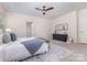 Light and airy main bedroom features a ceiling fan, ensuite access, and large windows at 11226 Dappled Light Trl, Charlotte, NC 28227