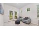 Cozy seating area with plush chairs, carpet, and a view of the private outdoor balcony at 11226 Dappled Light Trl, Charlotte, NC 28227
