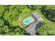 Aerial shot features the house with a fenced in pool, greenery, and concrete at 114 Larkfield Dr, Waxhaw, NC 28173
