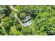 An aerial view highlights the home's lush surroundings and backyard pool at 114 Larkfield Dr, Waxhaw, NC 28173