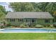 Backyard pool features a well-manicured lawn, steps, and a beautiful green home at 114 Larkfield Dr, Waxhaw, NC 28173