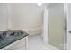A well-lit bathroom features a shower and a countertop sink with an open shelf at 114 Larkfield Dr, Waxhaw, NC 28173