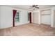 Bedroom features carpet floors, two windows, a ceiling fan and closet with built in shelves at 114 Larkfield Dr, Waxhaw, NC 28173