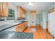 Bright kitchen features wooden cabinets, granite countertops and hardwood floors at 114 Larkfield Dr, Waxhaw, NC 28173