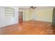 Spacious living room with hardwood floors, white built-ins and a ceiling fan at 114 Larkfield Dr, Waxhaw, NC 28173