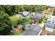 Expansive backyard with a pool, hot tub, and outdoor seating area, surrounded by mature trees at 117 N Central Ave, Belmont, NC 28012