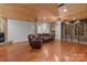 Spacious finished basement with hardwood floors, stone fireplace, wood plank ceiling, and comfortable seating area at 117 N Central Ave, Belmont, NC 28012
