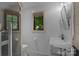 Charming bathroom with a window view, featuring penny tile floor and white subway tile shower at 117 N Central Ave, Belmont, NC 28012