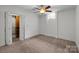 Bright bedroom with a ceiling fan, carpet floors, closet, and natural lighting from the window at 117 N Central Ave, Belmont, NC 28012