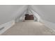 Bright and spacious bonus room featuring a neutral carpet and a comfortable seating area at 117 N Central Ave, Belmont, NC 28012