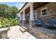 Inviting covered patio with stone pillars and flooring, offering comfortable outdoor seating at 117 N Central Ave, Belmont, NC 28012