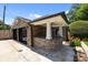 Exterior shot of a stone outdoor kitchen area next to garage and basketball hoop at 117 N Central Ave, Belmont, NC 28012