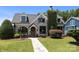 Charming brick home with a lush, landscaped front yard and inviting stone pathway at 117 N Central Ave, Belmont, NC 28012