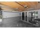 Spacious garage with a tongue and groove ceiling, bright lighting, and sealed floor at 117 N Central Ave, Belmont, NC 28012