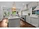 Gourmet kitchen with large island, Wolf range, and stylish pendant lighting at 117 N Central Ave, Belmont, NC 28012