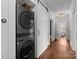 Modern laundry room with stackable washer/dryer and storage, and hallway access at 117 N Central Ave, Belmont, NC 28012