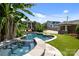 Beautiful pool, spa and outdoor kitchen area with tropical landscaping at 117 N Central Ave, Belmont, NC 28012