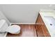 Bathroom featuring a white toilet, hardwood floors, and vanity with sink at 1314 San Gabriel Ave, Charlotte, NC 28214