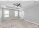 Spacious bedroom with large windows, ceiling fan, and neutral carpet at 1314 San Gabriel Ave, Charlotte, NC 28214