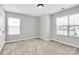 Bright bedroom with natural light from two windows, carpet, and neutral paint at 1314 San Gabriel Ave, Charlotte, NC 28214