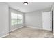 Bedroom featuring carpet, neutral paint, window with blinds, and door at 1314 San Gabriel Ave, Charlotte, NC 28214
