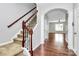 Inviting foyer with hardwood floors, staircase with rod iron spindles, and an arched entryway leading to the living area at 1314 San Gabriel Ave, Charlotte, NC 28214