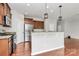Well-lit kitchen featuring stainless steel appliances, granite countertops, and wooden cabinets at 1314 San Gabriel Ave, Charlotte, NC 28214