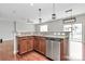 Open kitchen with granite countertops, stainless steel appliances and modern pendant lighting at 1314 San Gabriel Ave, Charlotte, NC 28214