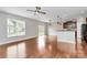 Open concept living area with hardwood floors, bar top dining, sliding glass doors, and modern lighting fixtures at 1314 San Gabriel Ave, Charlotte, NC 28214