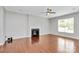 Well-lit living room with hardwood floors, fireplace, and large windows, offering a comfortable living space at 1314 San Gabriel Ave, Charlotte, NC 28214