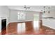 Bright living room with hardwood floors, a modern ceiling fan, a fireplace, and a view of the outdoor patio at 1314 San Gabriel Ave, Charlotte, NC 28214