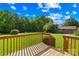 Wooden deck overlooking expansive green lawn, surrounded by mature trees at 13715 Mayes Rd, Huntersville, NC 28078