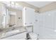 Bright bathroom featuring a granite vanity top and a white shower-tub combination at 13715 Mayes Rd, Huntersville, NC 28078