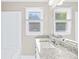 Bright bathroom with granite countertops, dual sinks, and natural light from the windows at 13715 Mayes Rd, Huntersville, NC 28078