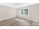 Inviting bedroom with ceiling fan and a large window offering outdoor views at 13715 Mayes Rd, Huntersville, NC 28078