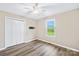 Well-lit bedroom featuring wood flooring, a ceiling fan and a double-door closet at 13715 Mayes Rd, Huntersville, NC 28078
