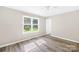 Cozy bedroom with natural light, complemented by hardwood flooring and neutral walls at 13715 Mayes Rd, Huntersville, NC 28078