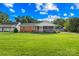 Traditional brick home with a screened-in porch and lush green yard at 13715 Mayes Rd, Huntersville, NC 28078