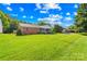 Well-maintained ranch home with a screened porch, surrounded by a beautiful green lawn at 13715 Mayes Rd, Huntersville, NC 28078