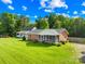 Charming brick home with screened-in porch and well-maintained lawn at 13715 Mayes Rd, Huntersville, NC 28078