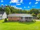 Charming brick ranch home with a screened porch and lush green lawn at 13715 Mayes Rd, Huntersville, NC 28078